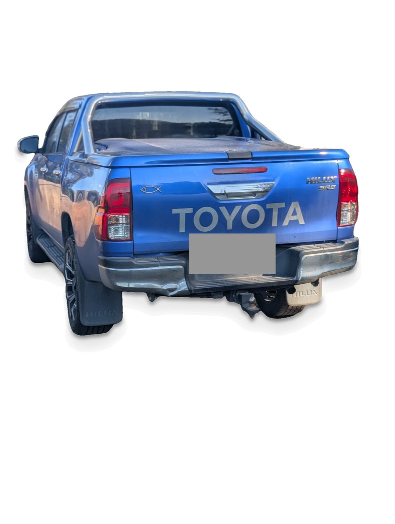 Before upgrade - white studio photo of the same Hilux; additional accessories shown; refer to pack inclusions
