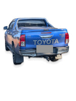 Before upgrade - white studio photo of the same Hilux; additional accessories shown; refer to pack inclusions